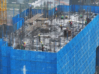 Workers work on the roof of a C&D Group property under construction in Nanjing, Jiangsu province, China, on November 15, 2024. On November 1...