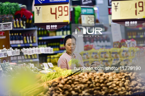 Consumers shop at a supermarket in Qingzhou, China, on November 15, 2024. On November 15, 2024, the National Bureau of Statistics releases d...