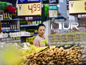 Consumers shop at a supermarket in Qingzhou, China, on November 15, 2024. On November 15, 2024, the National Bureau of Statistics releases d...