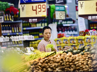 Consumers shop at a supermarket in Qingzhou, China, on November 15, 2024. On November 15, 2024, the National Bureau of Statistics releases d...