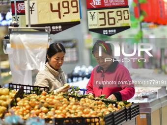 Consumers shop at a supermarket in Qingzhou, China, on November 15, 2024. On November 15, 2024, the National Bureau of Statistics releases d...