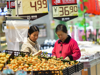 Consumers shop at a supermarket in Qingzhou, China, on November 15, 2024. On November 15, 2024, the National Bureau of Statistics releases d...