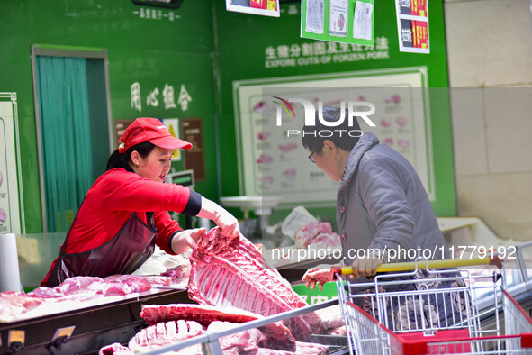 Consumers shop at a supermarket in Qingzhou, China, on November 15, 2024. On November 15, 2024, the National Bureau of Statistics releases d...