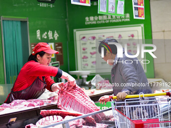 Consumers shop at a supermarket in Qingzhou, China, on November 15, 2024. On November 15, 2024, the National Bureau of Statistics releases d...