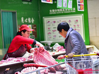 Consumers shop at a supermarket in Qingzhou, China, on November 15, 2024. On November 15, 2024, the National Bureau of Statistics releases d...