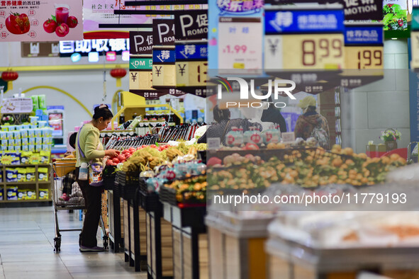 Consumers shop at a supermarket in Qingzhou, China, on November 15, 2024. On November 15, 2024, the National Bureau of Statistics releases d...