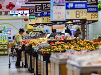 Consumers shop at a supermarket in Qingzhou, China, on November 15, 2024. On November 15, 2024, the National Bureau of Statistics releases d...