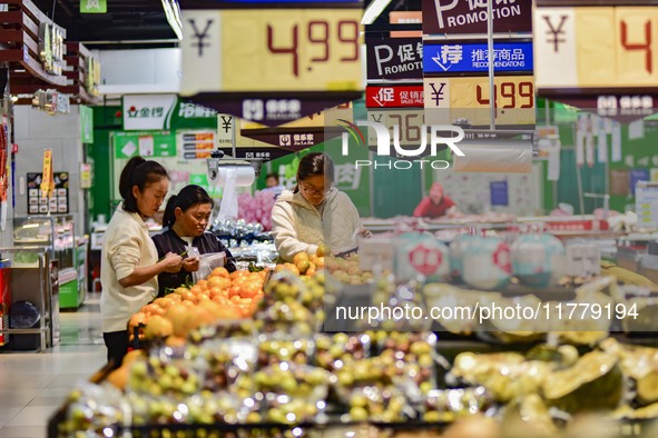 Consumers shop at a supermarket in Qingzhou, China, on November 15, 2024. On November 15, 2024, the National Bureau of Statistics releases d...