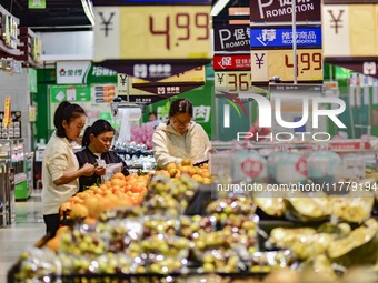 Consumers shop at a supermarket in Qingzhou, China, on November 15, 2024. On November 15, 2024, the National Bureau of Statistics releases d...