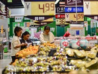 Consumers shop at a supermarket in Qingzhou, China, on November 15, 2024. On November 15, 2024, the National Bureau of Statistics releases d...