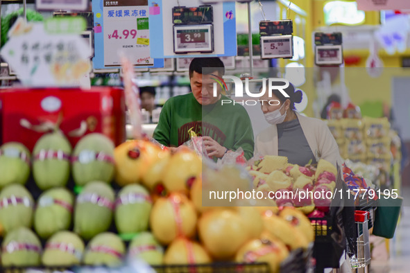 Consumers shop at a supermarket in Qingzhou, China, on November 15, 2024. On November 15, 2024, the National Bureau of Statistics releases d...