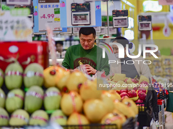 Consumers shop at a supermarket in Qingzhou, China, on November 15, 2024. On November 15, 2024, the National Bureau of Statistics releases d...