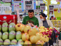 Consumers shop at a supermarket in Qingzhou, China, on November 15, 2024. On November 15, 2024, the National Bureau of Statistics releases d...