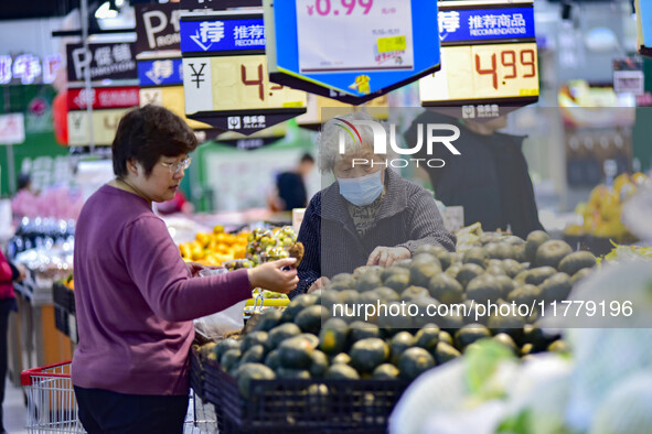 Consumers shop at a supermarket in Qingzhou, China, on November 15, 2024. On November 15, 2024, the National Bureau of Statistics releases d...