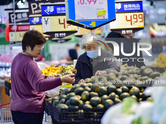 Consumers shop at a supermarket in Qingzhou, China, on November 15, 2024. On November 15, 2024, the National Bureau of Statistics releases d...