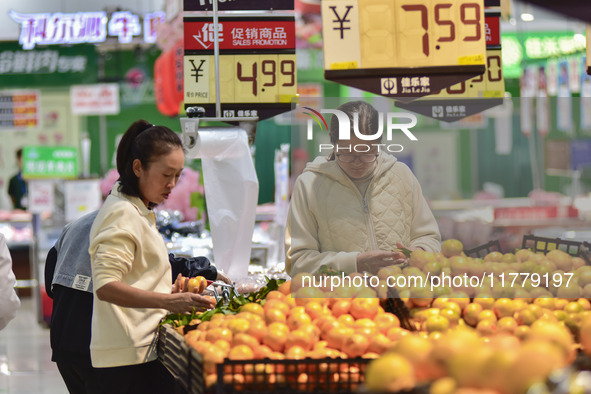 Consumers shop at a supermarket in Qingzhou, China, on November 15, 2024. On November 15, 2024, the National Bureau of Statistics releases d...