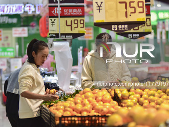 Consumers shop at a supermarket in Qingzhou, China, on November 15, 2024. On November 15, 2024, the National Bureau of Statistics releases d...