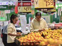 Consumers shop at a supermarket in Qingzhou, China, on November 15, 2024. On November 15, 2024, the National Bureau of Statistics releases d...