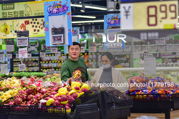 Consumers shop at a supermarket in Qingzhou, China, on November 15, 2024. On November 15, 2024, the National Bureau of Statistics releases d...