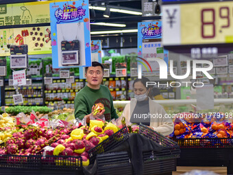 Consumers shop at a supermarket in Qingzhou, China, on November 15, 2024. On November 15, 2024, the National Bureau of Statistics releases d...