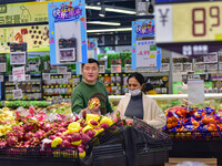 Consumers shop at a supermarket in Qingzhou, China, on November 15, 2024. On November 15, 2024, the National Bureau of Statistics releases d...