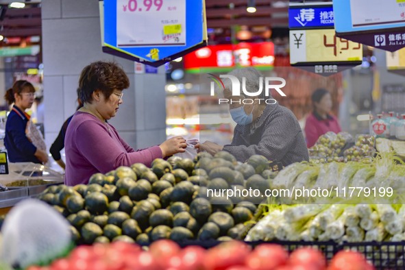 Consumers shop at a supermarket in Qingzhou, China, on November 15, 2024. On November 15, 2024, the National Bureau of Statistics releases d...