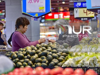 Consumers shop at a supermarket in Qingzhou, China, on November 15, 2024. On November 15, 2024, the National Bureau of Statistics releases d...