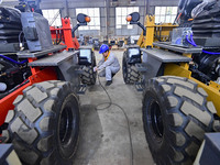 A worker works at a loader manufacturing enterprise in Qingzhou Economic Development Zone, East China's Shandong province, on November 15, 2...