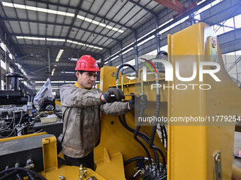 A worker works at a loader manufacturing enterprise in Qingzhou Economic Development Zone, East China's Shandong province, on November 15, 2...