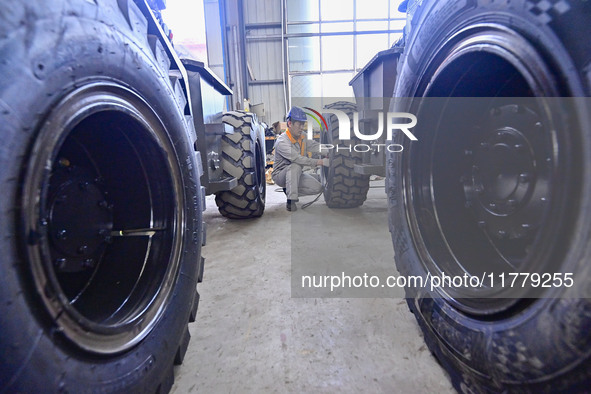 A worker works at a loader manufacturing enterprise in Qingzhou Economic Development Zone, East China's Shandong province, on November 15, 2...