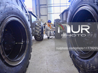 A worker works at a loader manufacturing enterprise in Qingzhou Economic Development Zone, East China's Shandong province, on November 15, 2...