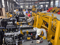 A worker works at a loader manufacturing enterprise in Qingzhou Economic Development Zone, East China's Shandong province, on November 15, 2...