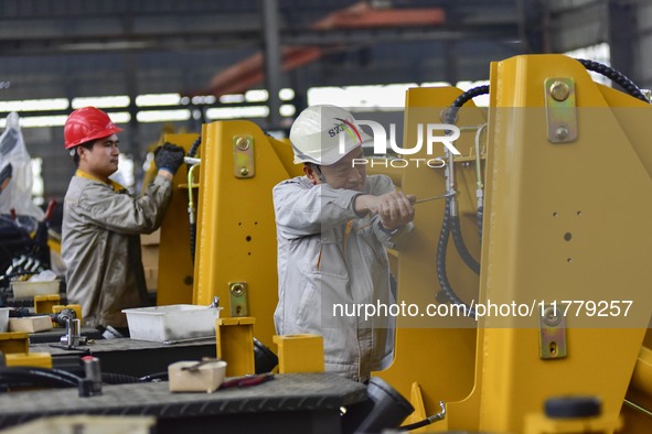 A worker works at a loader manufacturing enterprise in Qingzhou Economic Development Zone, East China's Shandong province, on November 15, 2...