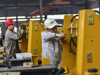 A worker works at a loader manufacturing enterprise in Qingzhou Economic Development Zone, East China's Shandong province, on November 15, 2...