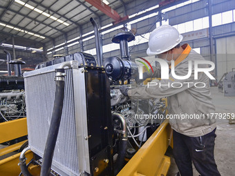 A worker works at a loader manufacturing enterprise in Qingzhou Economic Development Zone, East China's Shandong province, on November 15, 2...