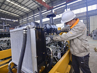 A worker works at a loader manufacturing enterprise in Qingzhou Economic Development Zone, East China's Shandong province, on November 15, 2...