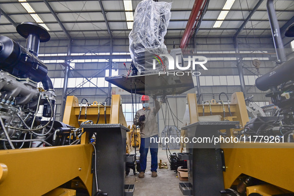 A worker works at a loader manufacturing enterprise in Qingzhou Economic Development Zone, East China's Shandong province, on November 15, 2...