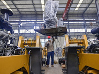 A worker works at a loader manufacturing enterprise in Qingzhou Economic Development Zone, East China's Shandong province, on November 15, 2...