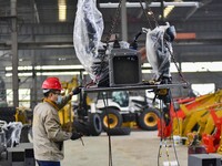 A worker works at a loader manufacturing enterprise in Qingzhou Economic Development Zone, East China's Shandong province, on November 15, 2...