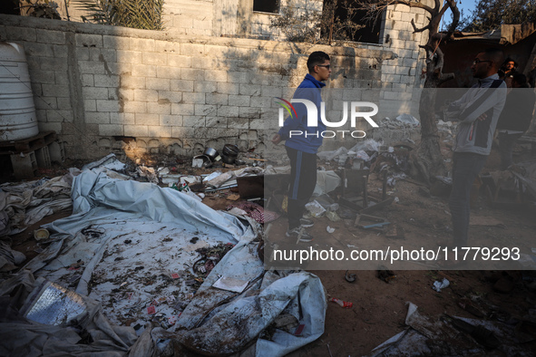 Palestinians inspect the site of an Israeli strike on tents of displaced people in Deir Al-Balah, Gaza Strip, on November 15, 2024. 