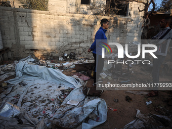 Palestinians inspect the site of an Israeli strike on tents of displaced people in Deir Al-Balah, Gaza Strip, on November 15, 2024. (