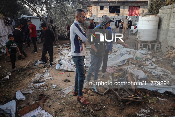 Palestinians inspect the site of an Israeli strike on tents of displaced people in Deir Al-Balah, Gaza Strip, on November 15, 2024. 