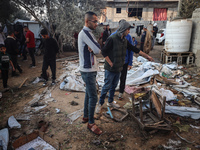 Palestinians inspect the site of an Israeli strike on tents of displaced people in Deir Al-Balah, Gaza Strip, on November 15, 2024. (