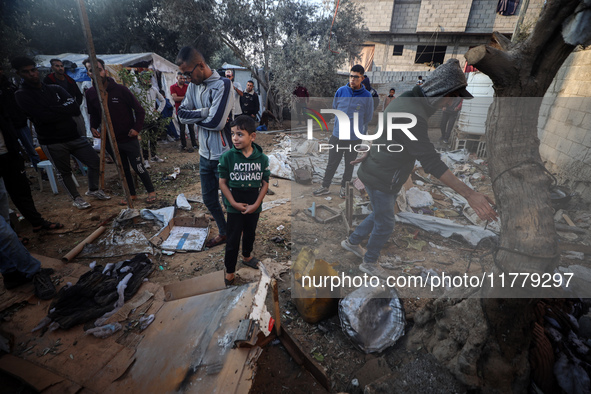 Palestinians inspect the site of an Israeli strike on tents of displaced people in Deir Al-Balah, Gaza Strip, on November 15, 2024. 