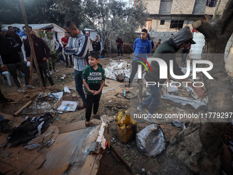 Palestinians inspect the site of an Israeli strike on tents of displaced people in Deir Al-Balah, Gaza Strip, on November 15, 2024. (