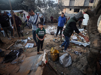 Palestinians inspect the site of an Israeli strike on tents of displaced people in Deir Al-Balah, Gaza Strip, on November 15, 2024. (