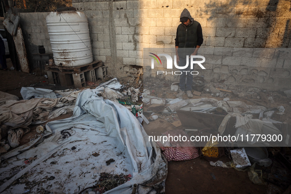 A Palestinian man inspects the site of an Israeli strike on tents of displaced people in Deir Al-Balah, Gaza Strip, on November 15, 2024. 