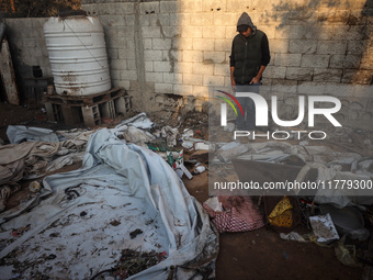 A Palestinian man inspects the site of an Israeli strike on tents of displaced people in Deir Al-Balah, Gaza Strip, on November 15, 2024. (