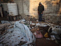 A Palestinian man inspects the site of an Israeli strike on tents of displaced people in Deir Al-Balah, Gaza Strip, on November 15, 2024. (