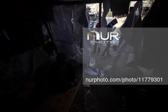 Palestinians inspect the site of an Israeli strike on tents of displaced people in Deir Al-Balah, Gaza Strip, on November 15, 2024. 